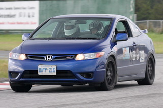 Mark with his passenger coming out on the front straight...